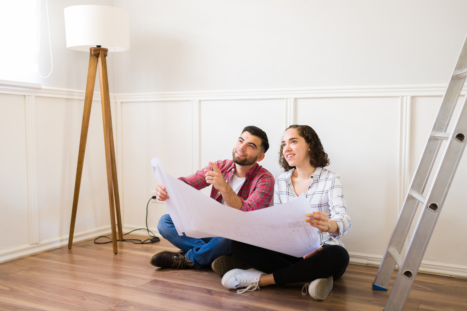 Smiling couple renovating and doing home improvements